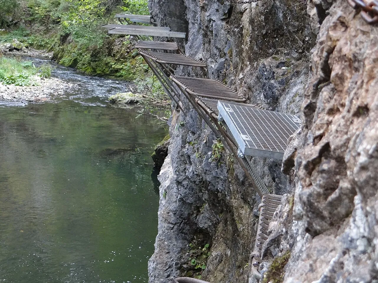Cliffside trail suspended above water
